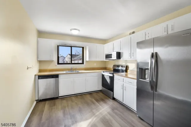 a kitchen with a refrigerator and a sink
