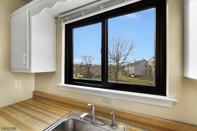 a view of a room that has a bed and a window