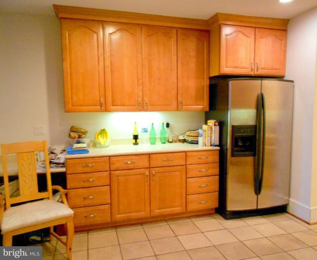 1260 Columbia Road Northwest Washington, DC 20009 - Photo 14 of 19 a kitchen with a refrigerator and cabinets