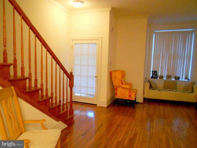 1260 Columbia Road Northwest Washington, DC 20009 - Photo 17 of 19 a view of an entryway with wooden floor and door