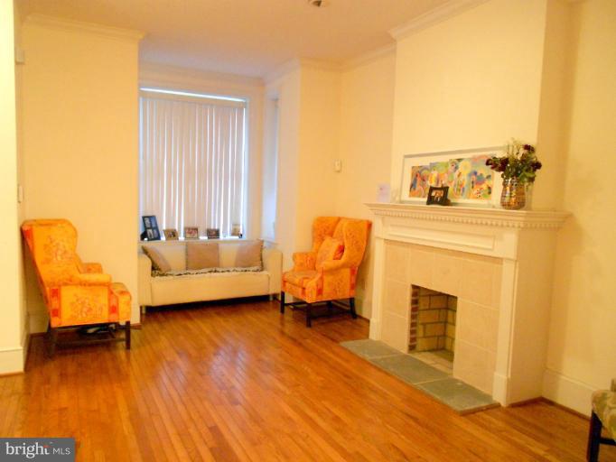 1260 Columbia Road Northwest Washington, DC 20009 - Photo 18 of 19 a living room with furniture and a fireplace