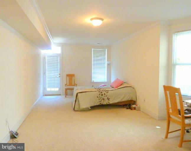 1260 Columbia Road Northwest Washington, DC 20009 - Photo 3 of 19 a spacious bedroom with a bed and chair