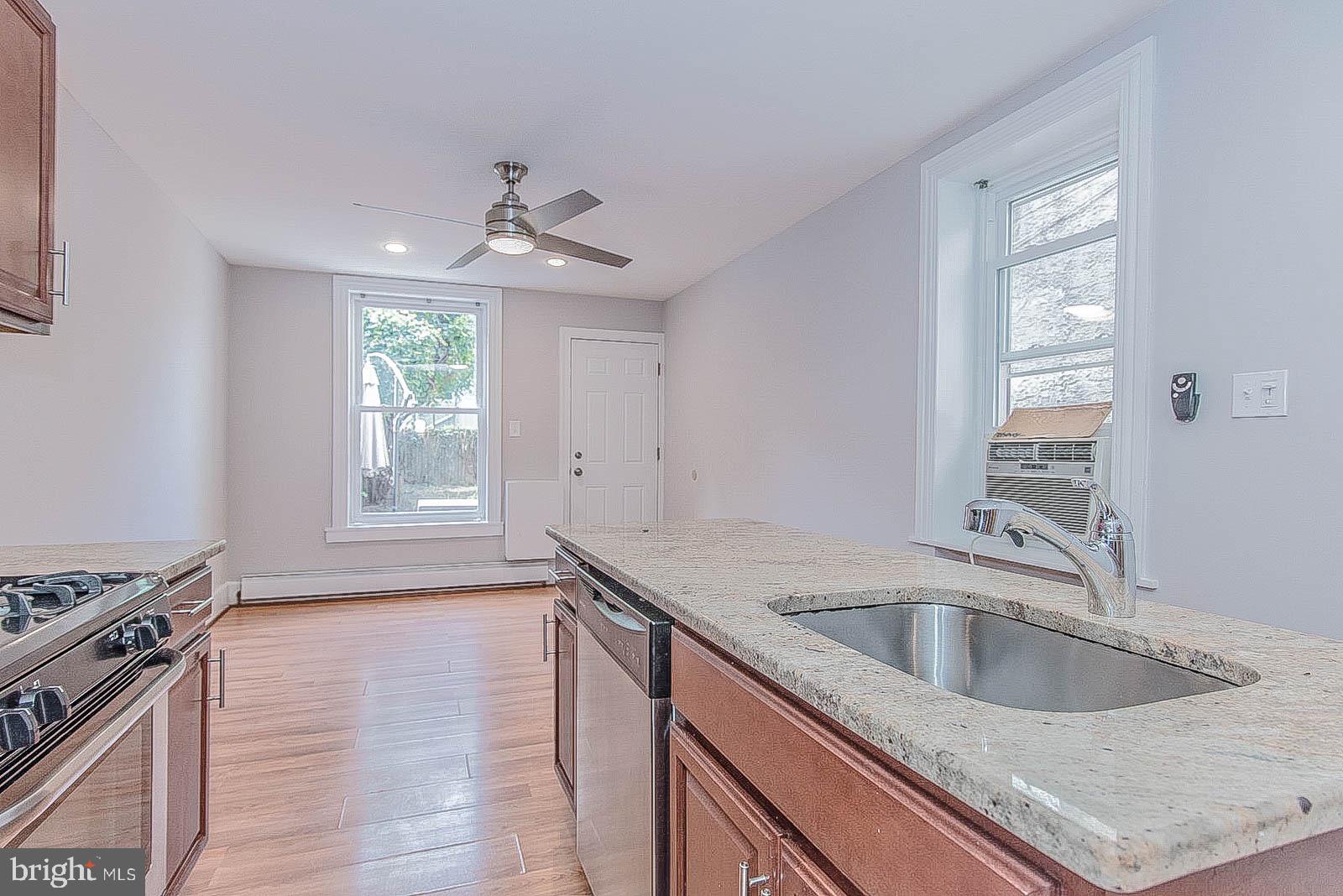 2022 Ogden Street Philadelphia, PA 19130 - Photo 11 of 44 a kitchen with a sink granite top and a stove