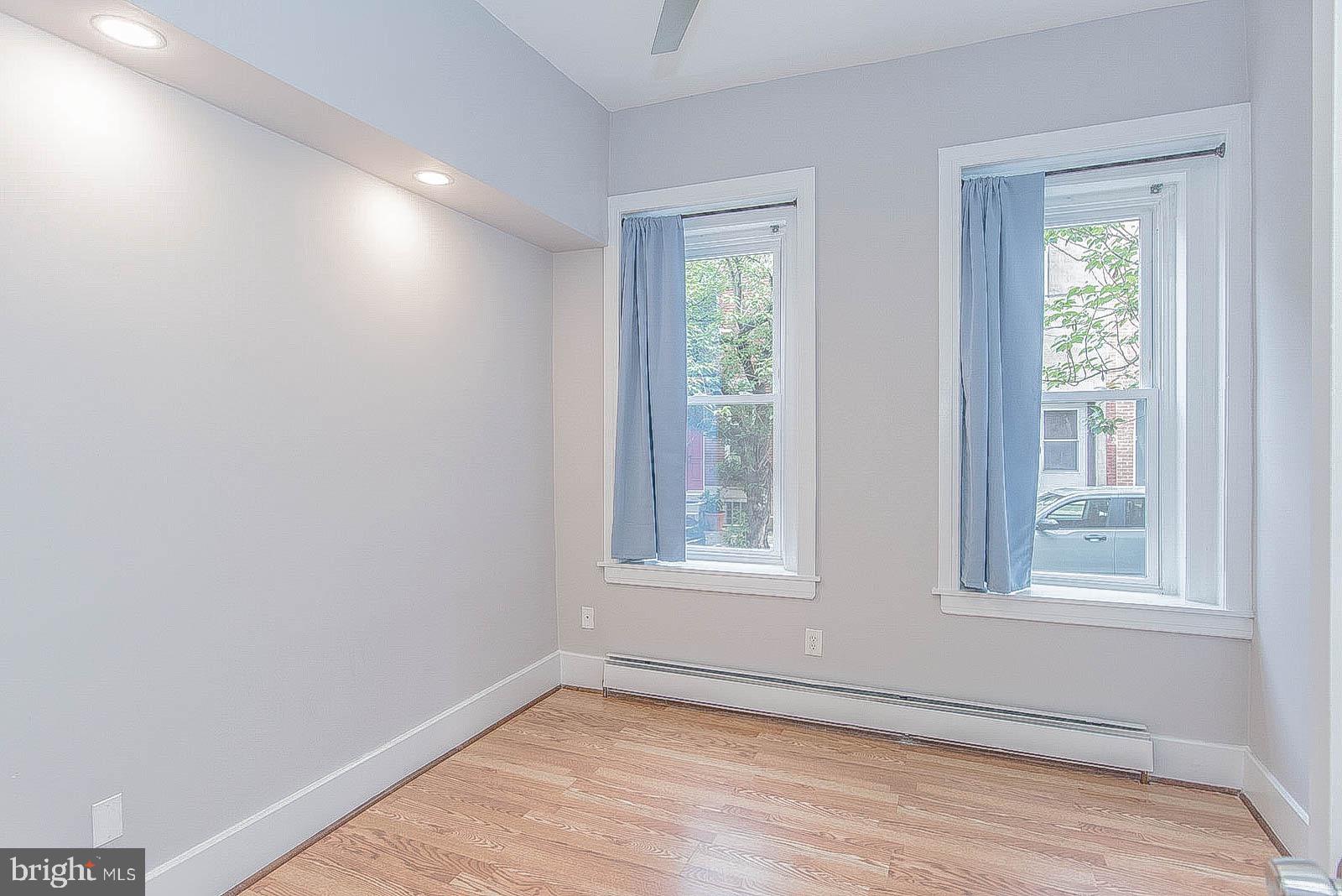 2022 Ogden Street Philadelphia, PA 19130 - Photo 18 of 44 an empty room with wooden floor and windows
