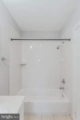 a bathroom with a sink mirror and toilet