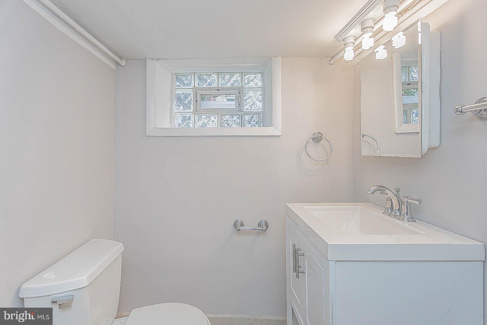 2022 Ogden Street Philadelphia, PA 19130 - Photo 30 of 44 a bathroom with a sink mirror and toilet