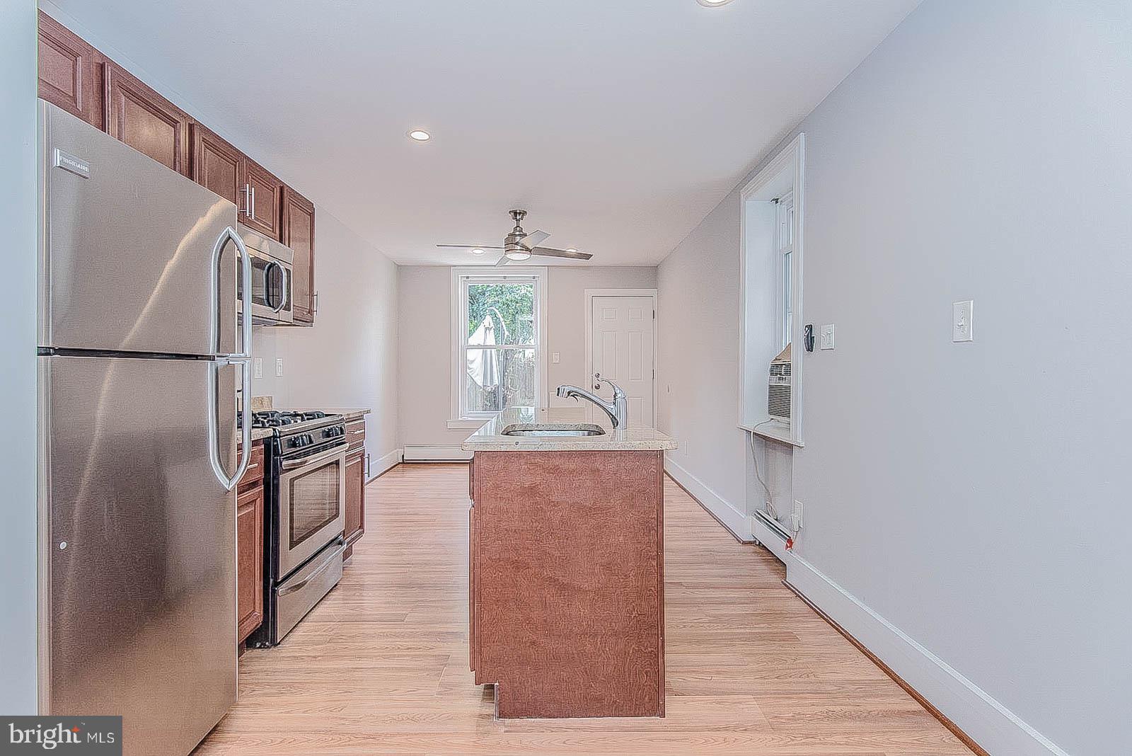 2022 Ogden Street Philadelphia, PA 19130 - Photo 3 of 44 a kitchen with stainless steel appliances granite countertop a refrigerator a stove and a sink