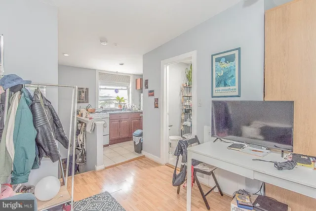 a room with a sink cabinets and window