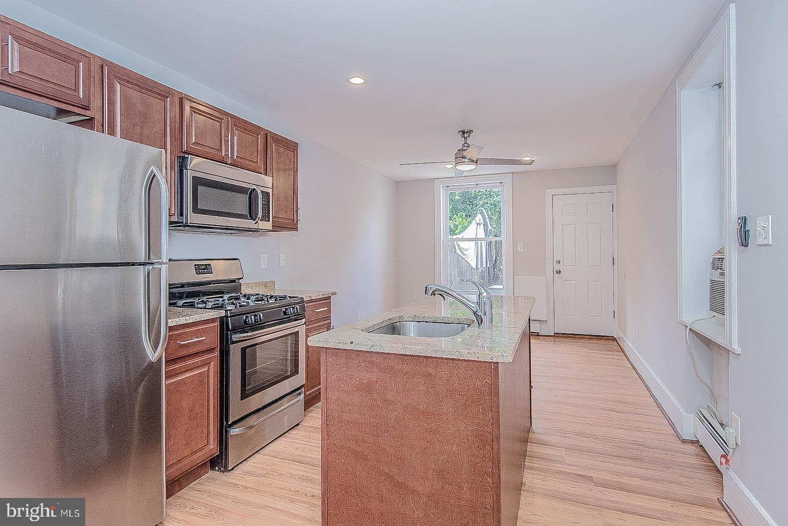 2022 Ogden Street Philadelphia, PA 19130 - Photo 4 of 44 a kitchen with stainless steel appliances granite countertop a refrigerator stove and sink