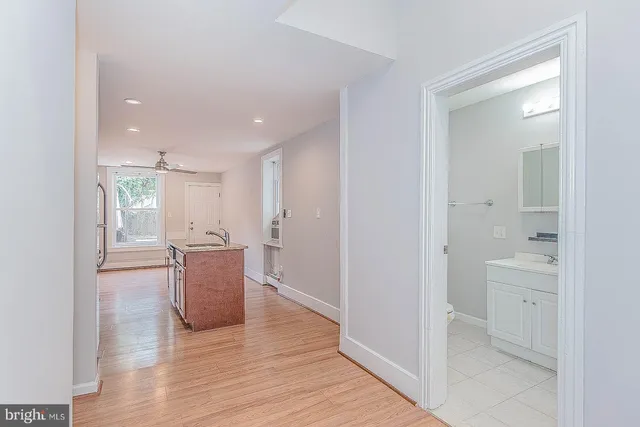 a kitchen with stainless steel appliances granite countertop a refrigerator a stove top oven a sink dishwasher and wooden cabinets