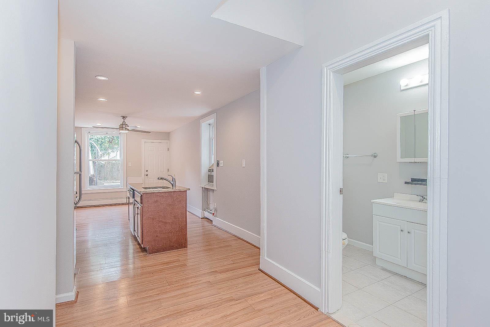 2022 Ogden Street Philadelphia, PA 19130 - Photo 6 of 44 a view of a kitchen with a sink and dishwasher a refrigerator with wooden floor