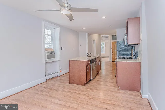 a view of a kitchen with wooden floor and electronic appliances