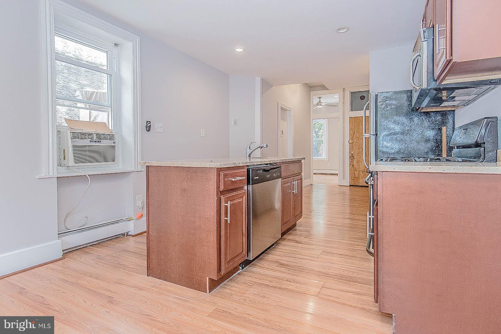 2022 Ogden Street Philadelphia, PA 19130 - Photo 9 of 44 a view of a kitchen with wooden floor and electronic appliances
