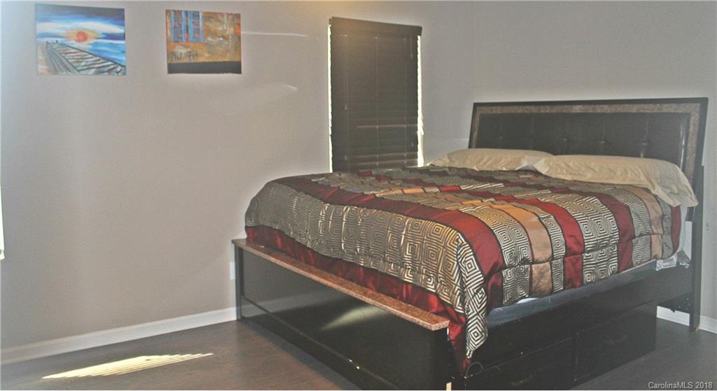 519 Rook Road Charlotte, NC 28216 - Photo 13 of 20 a bedroom with a bed and wall painting