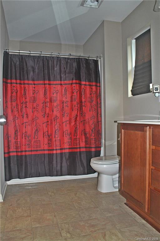 519 Rook Road Charlotte, NC 28216 - Photo 15 of 20 a bathroom with a toilet and a shower curtain