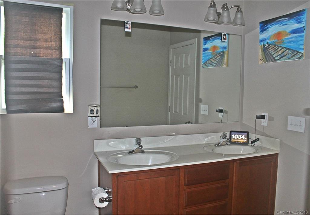 519 Rook Road Charlotte, NC 28216 - Photo 16 of 20 a bathroom with a granite countertop sink toilet and a mirror