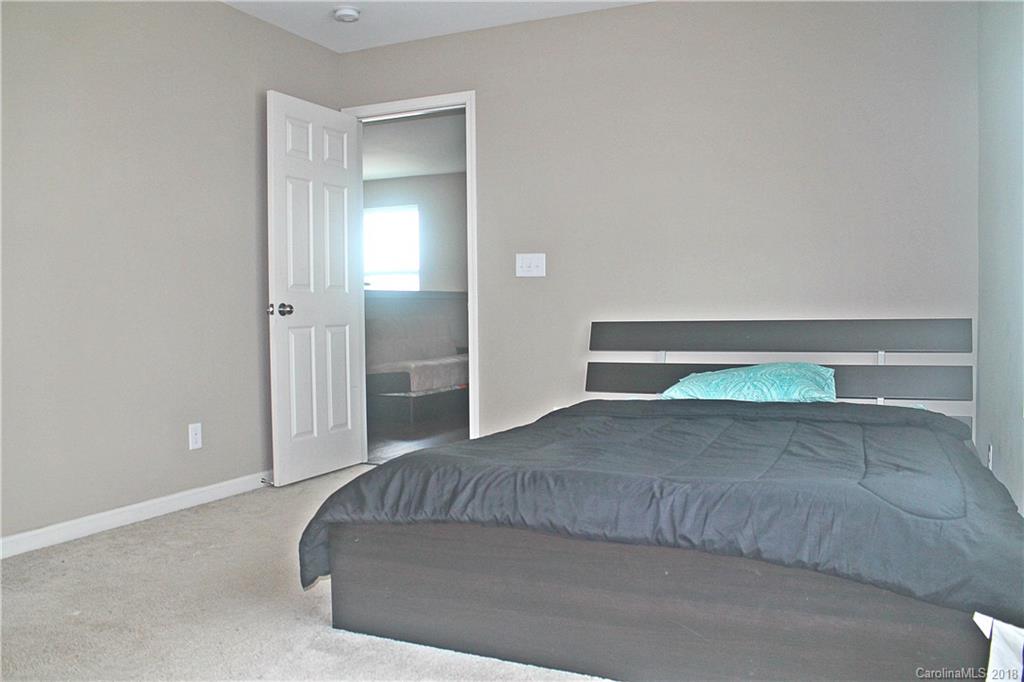 519 Rook Road Charlotte, NC 28216 - Photo 17 of 20 a living room with a bed and a lamp