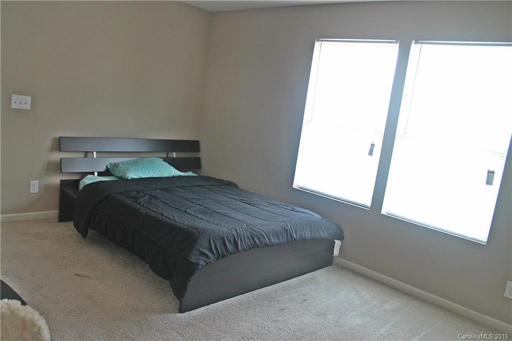 519 Rook Road Charlotte, NC 28216 - Photo 18 of 20 a bedroom with a bed and a window