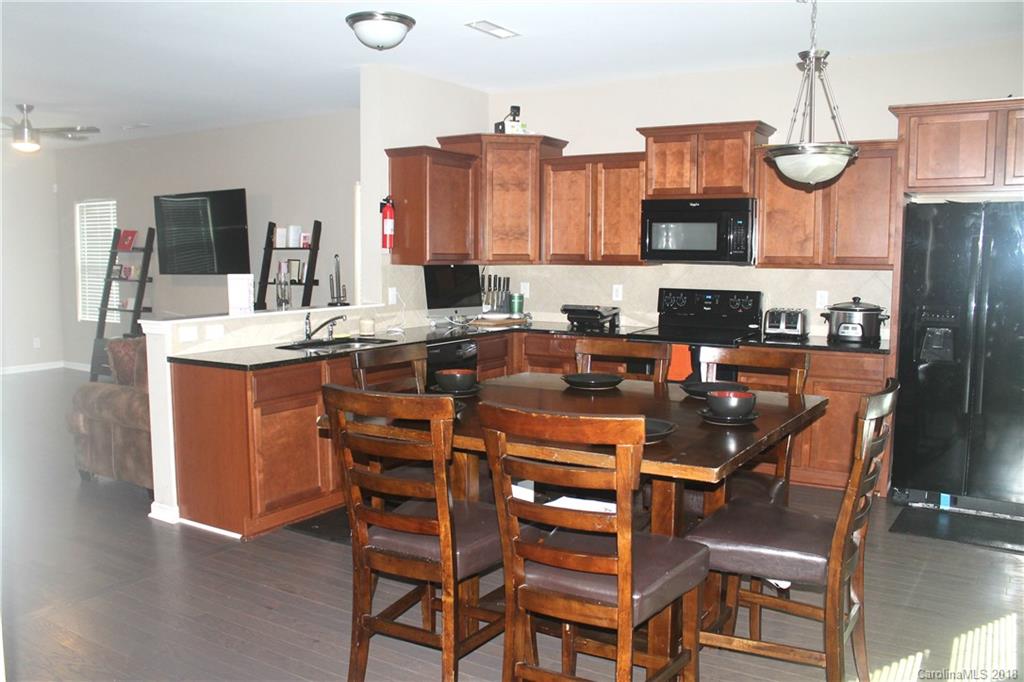 519 Rook Road Charlotte, NC 28216 - Photo 5 of 20 a kitchen with stainless steel appliances granite countertop a sink a stove and a refrigerator