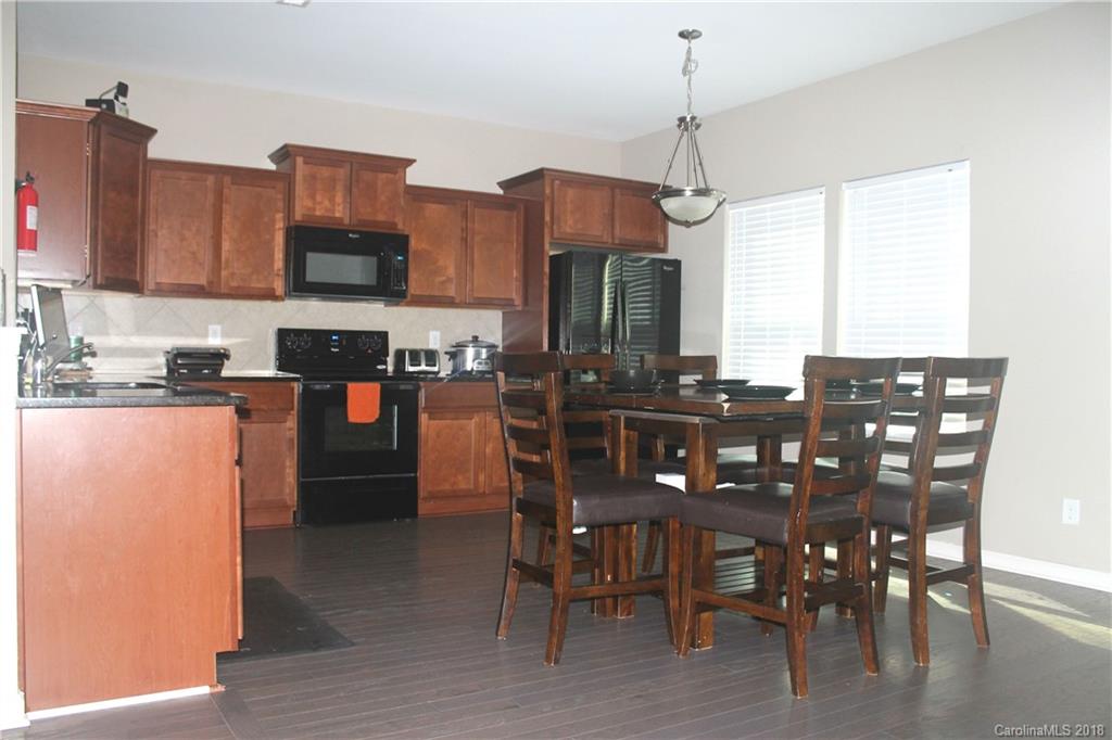 519 Rook Road Charlotte, NC 28216 - Photo 6 of 20 a view of a dining room with furniture window and wooden floor