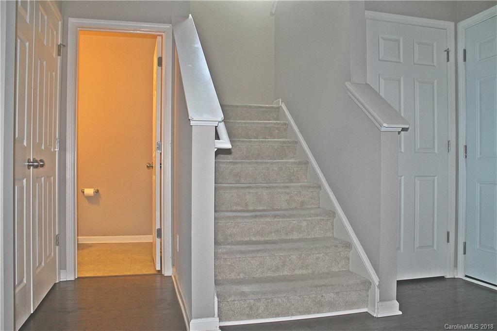 519 Rook Road Charlotte, NC 28216 - Photo 7 of 20 a view of staircase with white walls and white door
