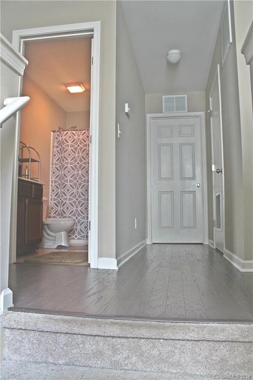 519 Rook Road Charlotte, NC 28216 - Photo 9 of 20 a view of a hallway with wooden floor and a living room