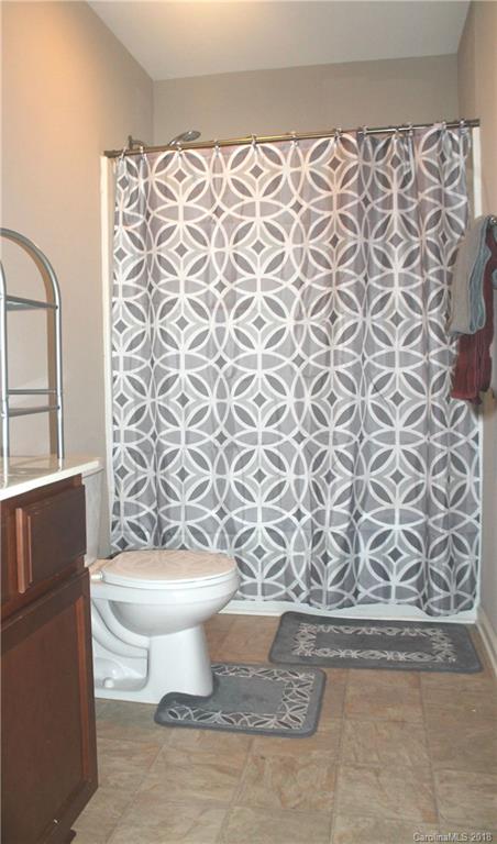 519 Rook Road Charlotte, NC 28216 - Photo 10 of 20 a white toilet sitting next to a shower curtain