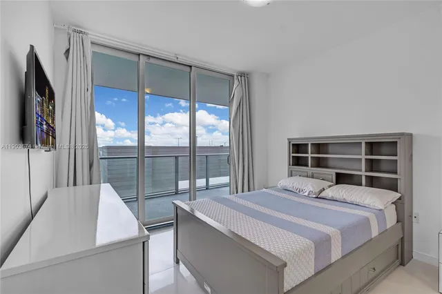 a bedroom with a bed and glass window