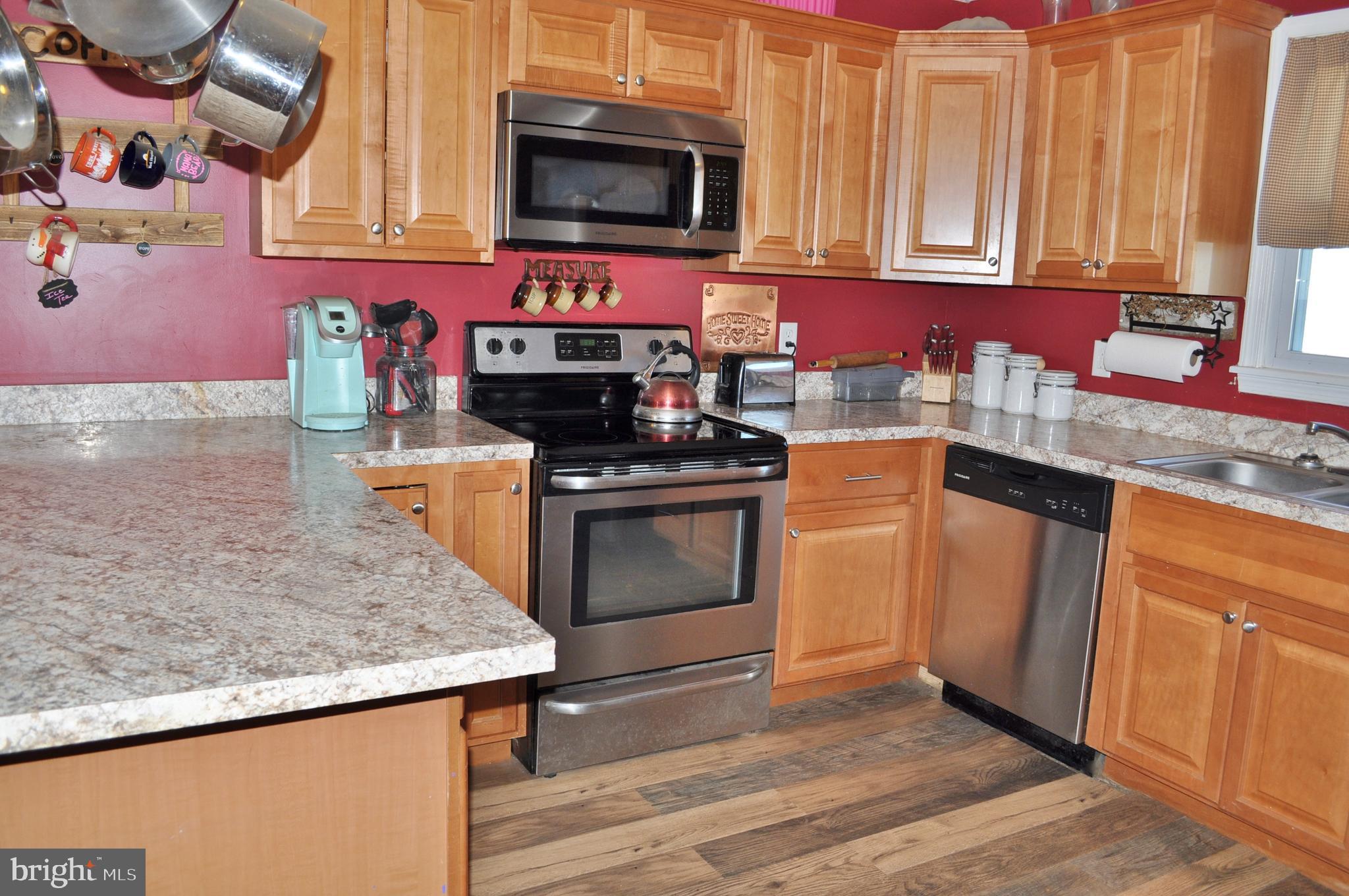 1976 Stoverstown Road Spring Grove, PA 17362 - Photo 12 of 66 a kitchen with stainless steel appliances granite countertop a stove a sink and a microwave