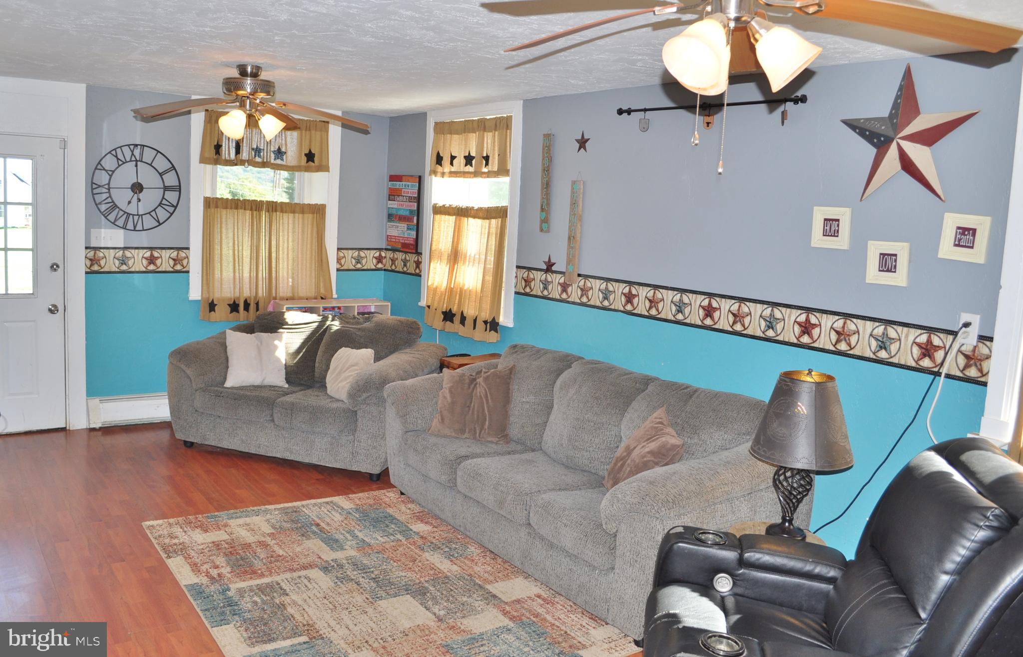 1976 Stoverstown Road Spring Grove, PA 17362 - Photo 15 of 66 a living room with furniture chandelier and a window