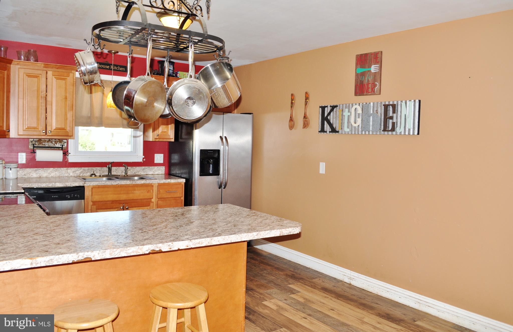 1976 Stoverstown Road Spring Grove, PA 17362 - Photo 6 of 66 a kitchen with stainless steel appliances granite countertop a sink a microwave cabinets and a dining table