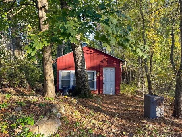 a backyard of a house with a tree