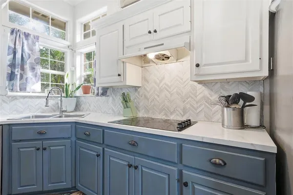 a kitchen with a sink and cabinets