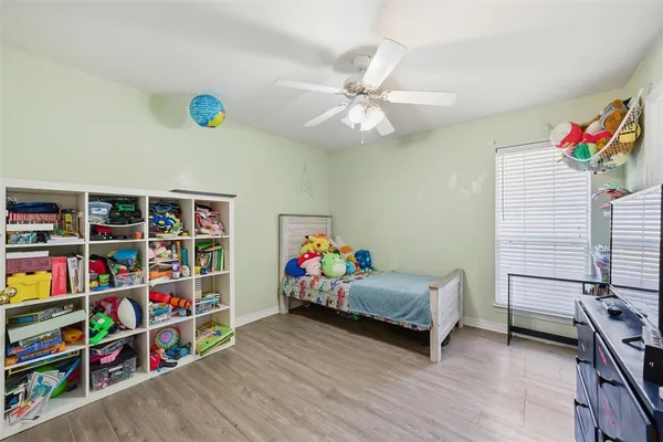 a bedroom with furniture and a book shelf