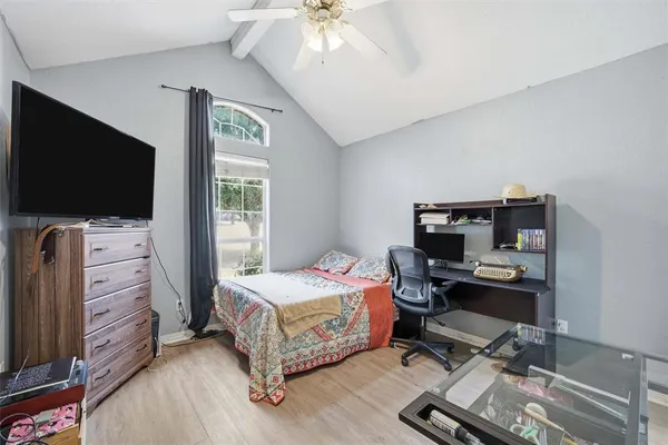 a bedroom with a bed and a flat screen tv