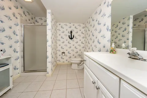 a bathroom with a sink toilet and shower