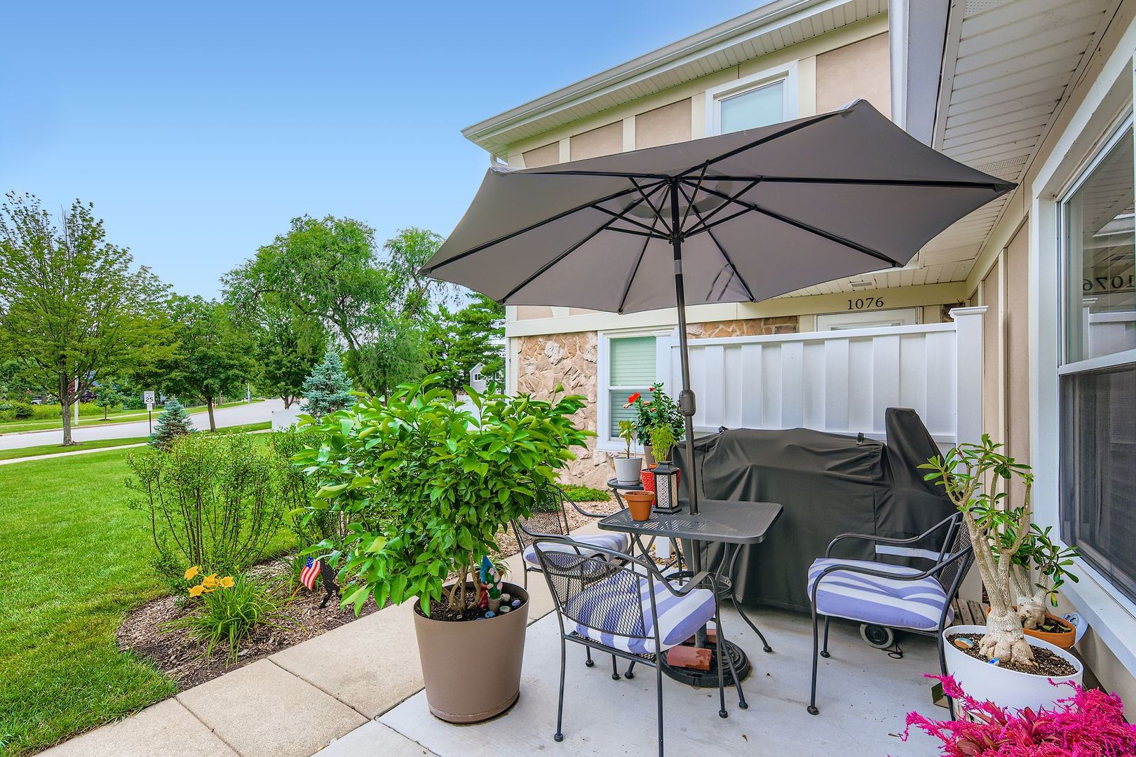 1078 Newport Harbor, Unit 1078 Schaumburg, IL 60193 - Photo 11 of 13 a view of a chair and table in the backyard with potted plants