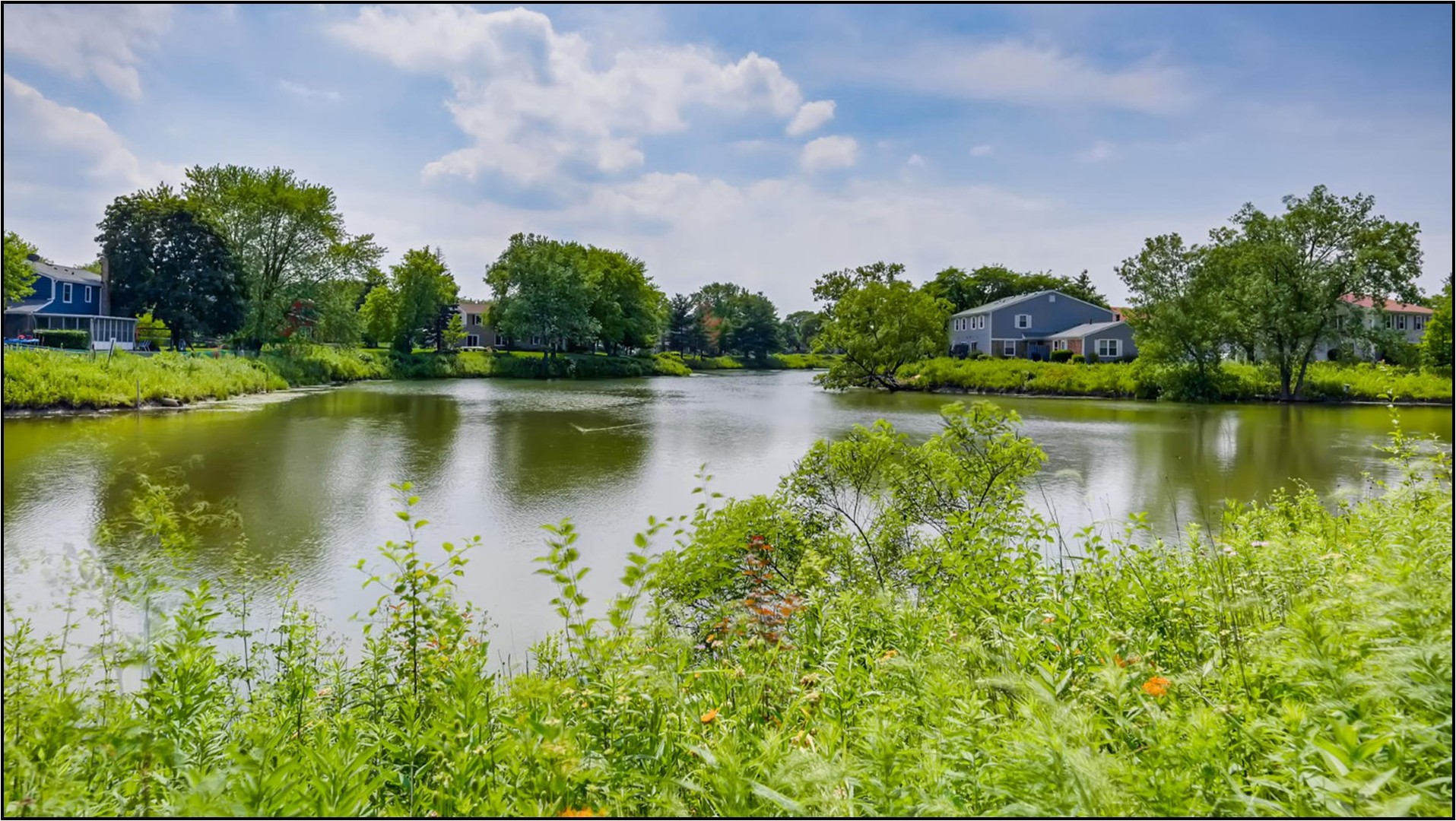 1078 Newport Harbor, Unit 1078 Schaumburg, IL 60193 - Photo 13 of 13 a view of a lake with houses in the background