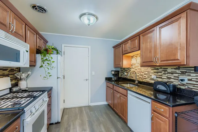 a kitchen with stainless steel appliances granite countertop a stove and a sink
