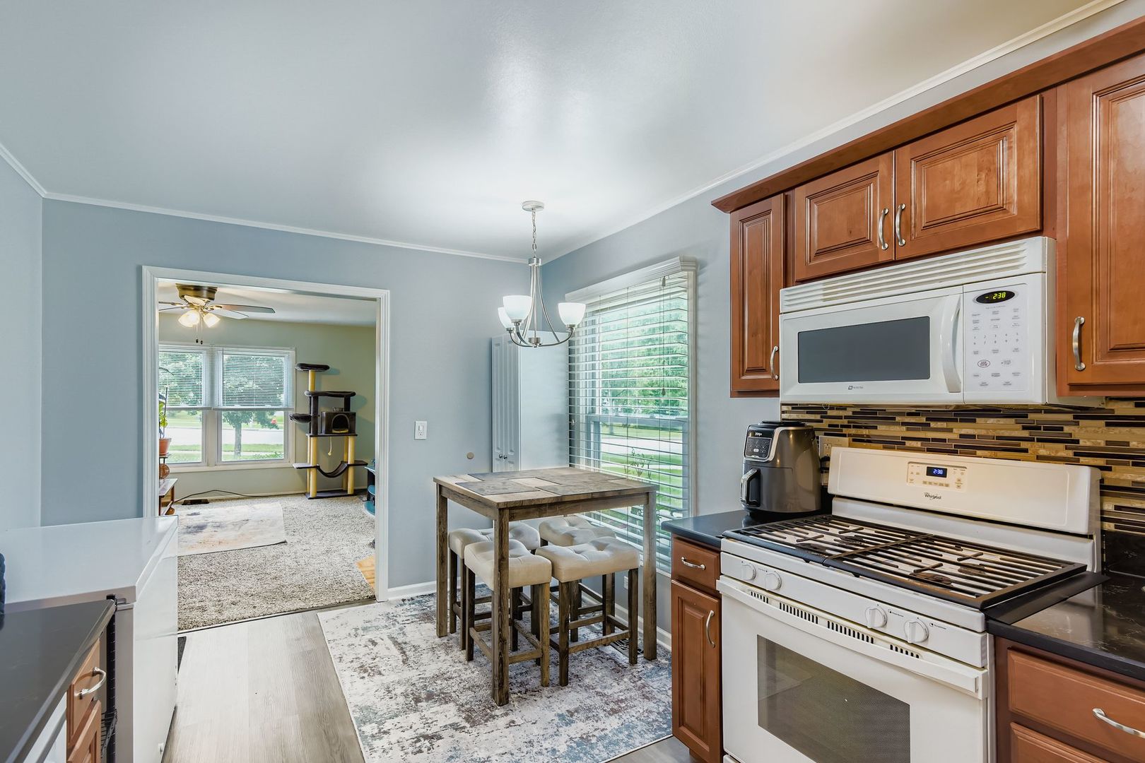 1078 Newport Harbor, Unit 1078 Schaumburg, IL 60193 - Photo 4 of 13 a kitchen with a stove and a wooden floor