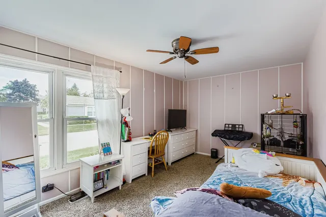 a bedroom with furniture and a window