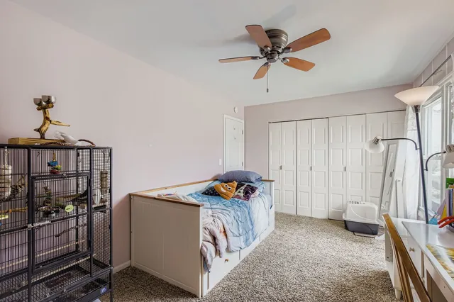 a living room with furniture and a ceiling fan