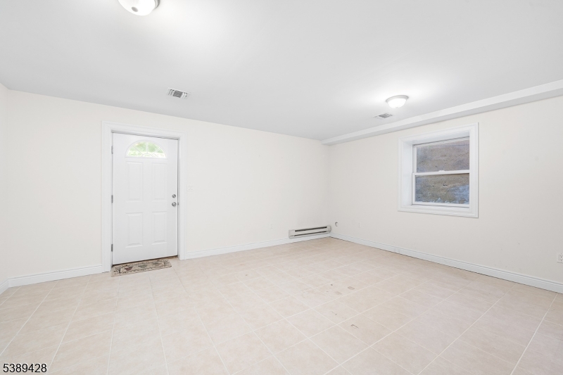 233 5th Street, Unit B Fairview, NJ 07022 - Photo 27 of 31 an empty room with a empty space and windows
