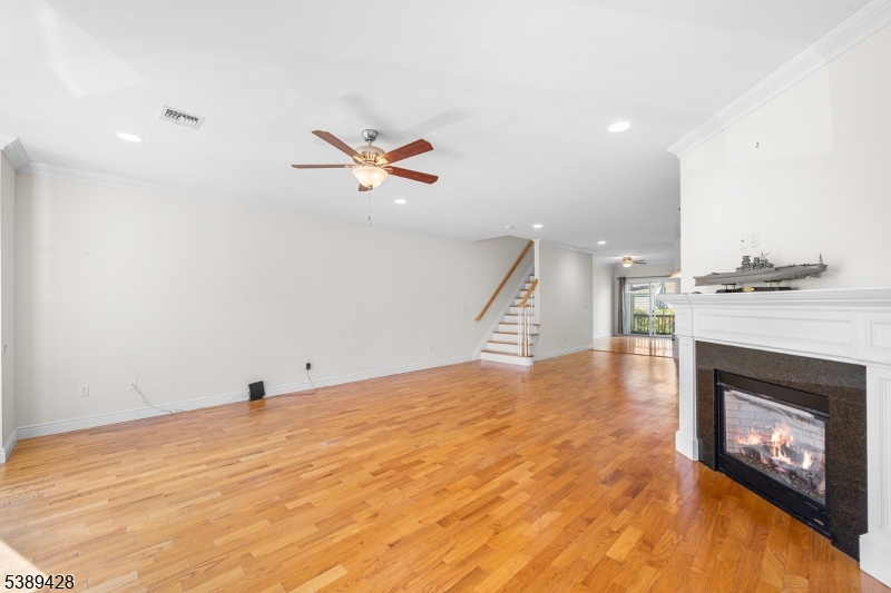 233 5th Street, Unit B Fairview, NJ 07022 - Photo 4 of 31 a view of an empty room with a fireplace