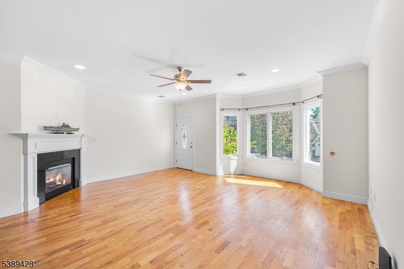 233 5th Street, Unit B Fairview, NJ 07022 - Photo 5 of 31 a view of an empty room with a fireplace and a window