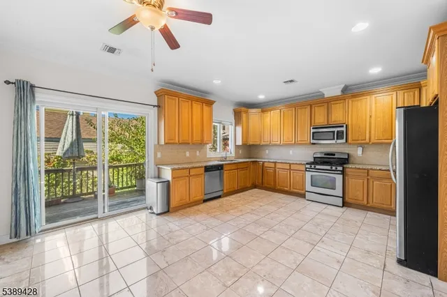 a kitchen with stainless steel appliances granite countertop a stove a sink and a refrigerator
