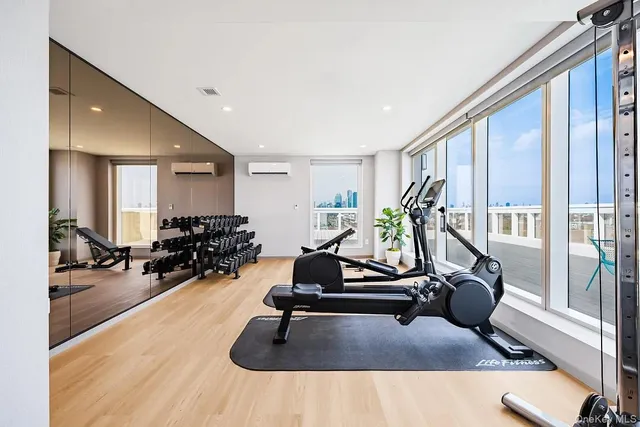 a room with gym equipment and a large window