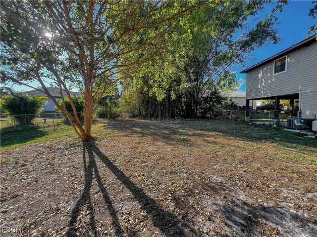a view of a backyard with large trees