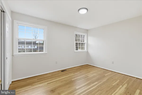 a view of a room with wooden floor