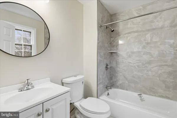 a view of a room with wooden floor and windows